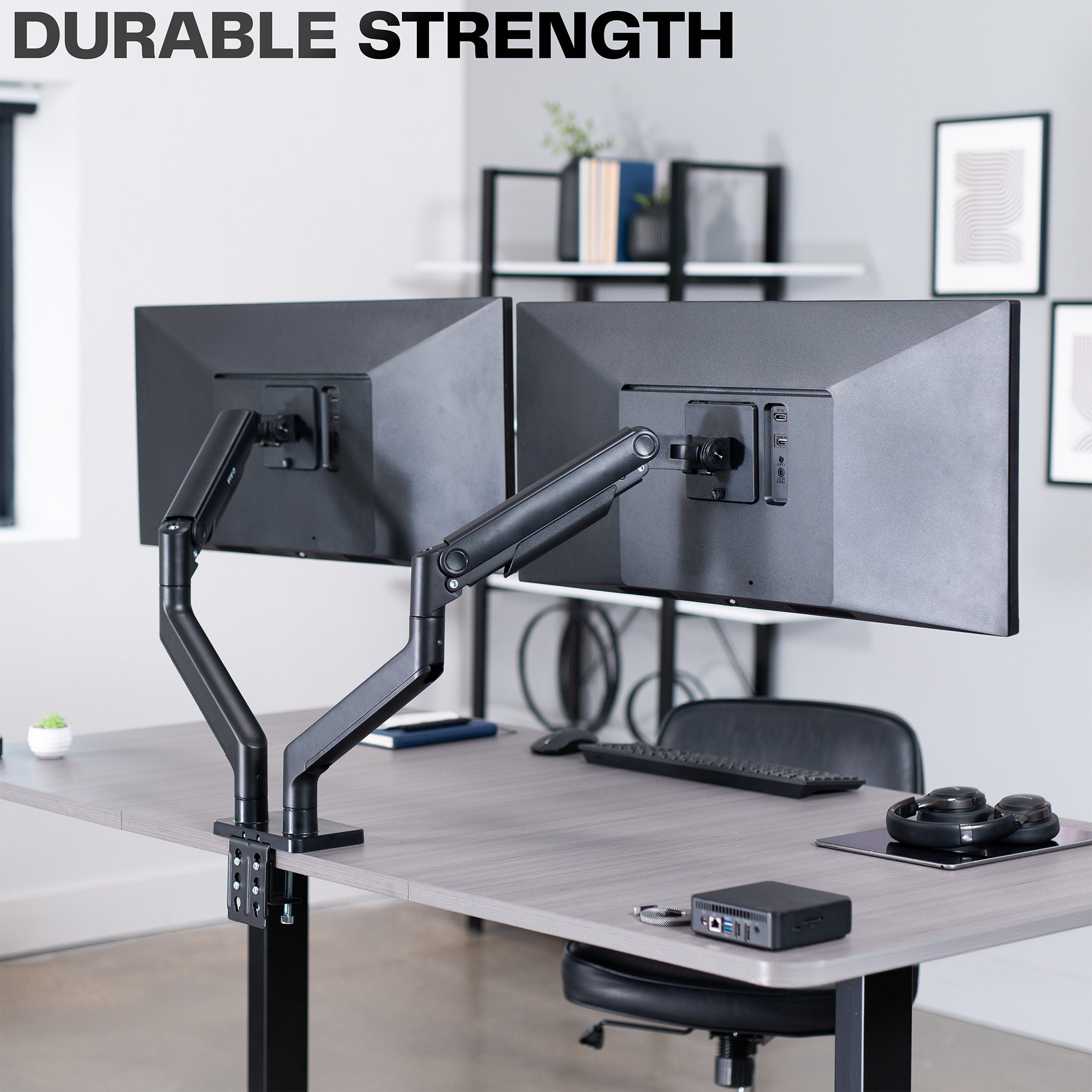 A dual monitor desk mount with pneumatic arms with text displaying durability.