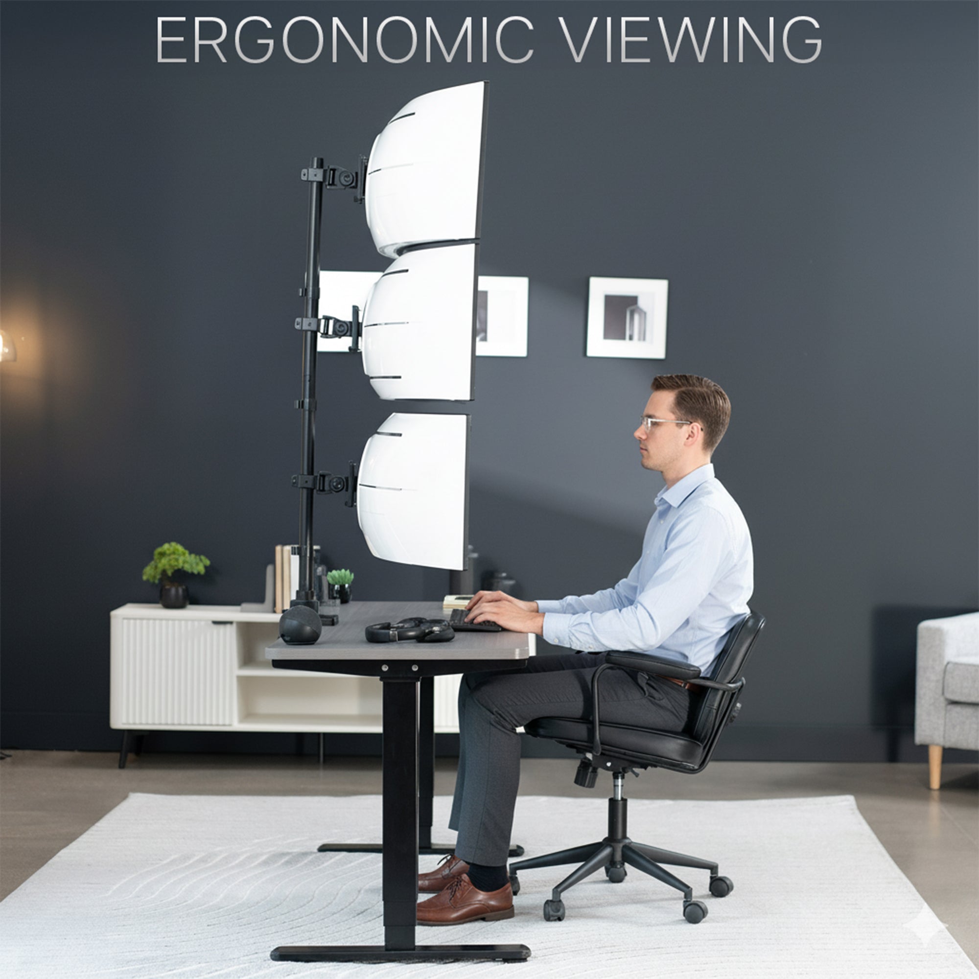Person sitting at a desk with an ergonomic setup in a modern office setting.