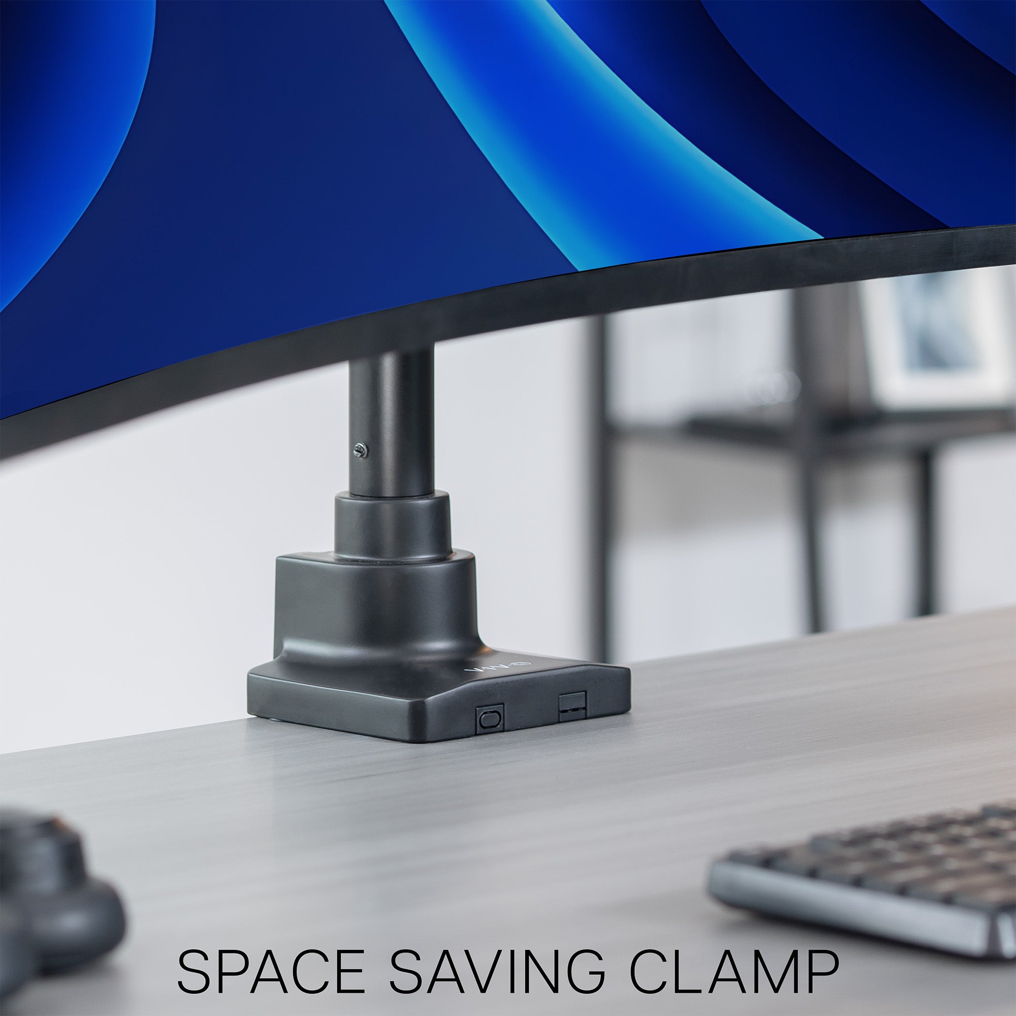 Space-saving clamp attached to a desk with a blurred background