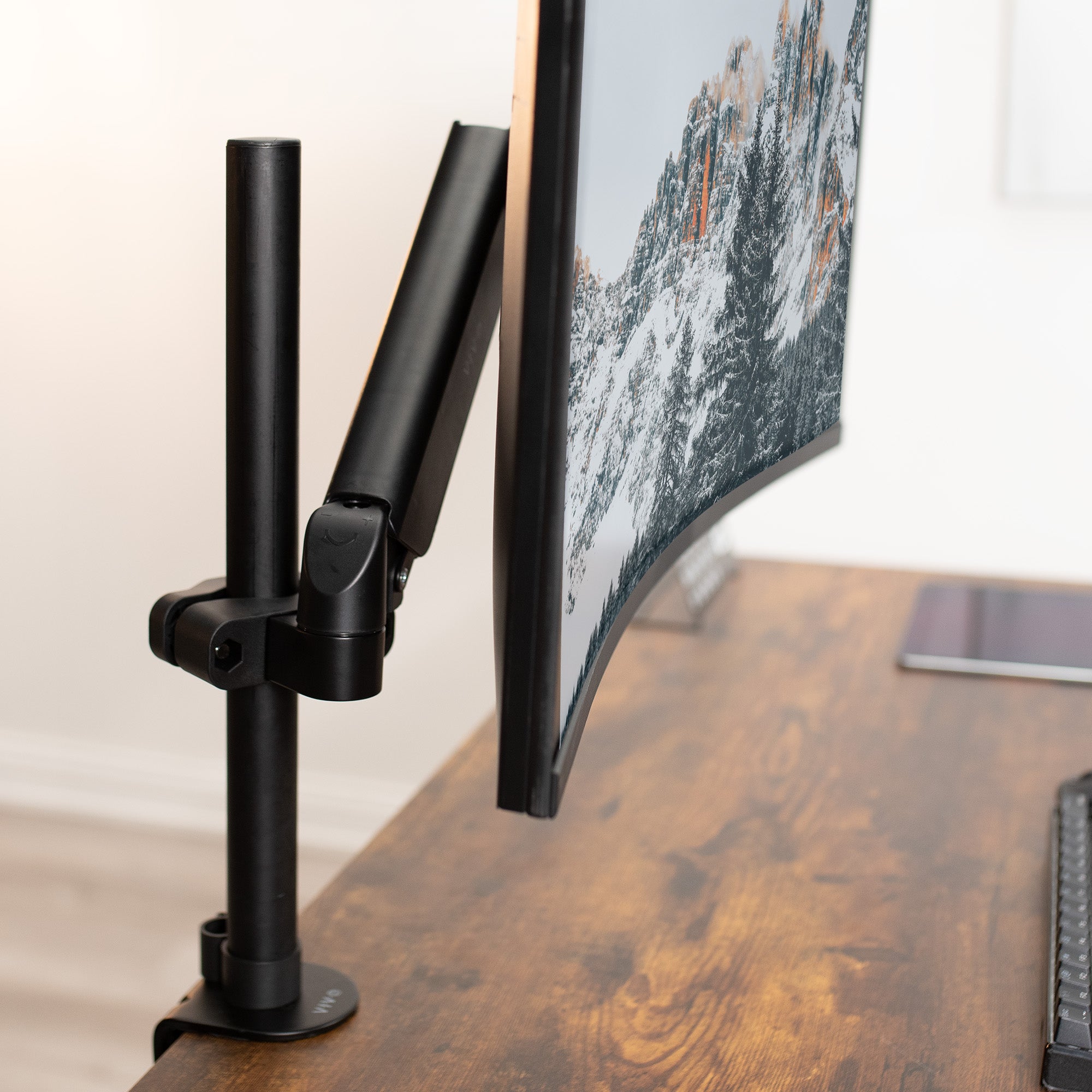 Adjustable monitor mount arm supporting large screen.