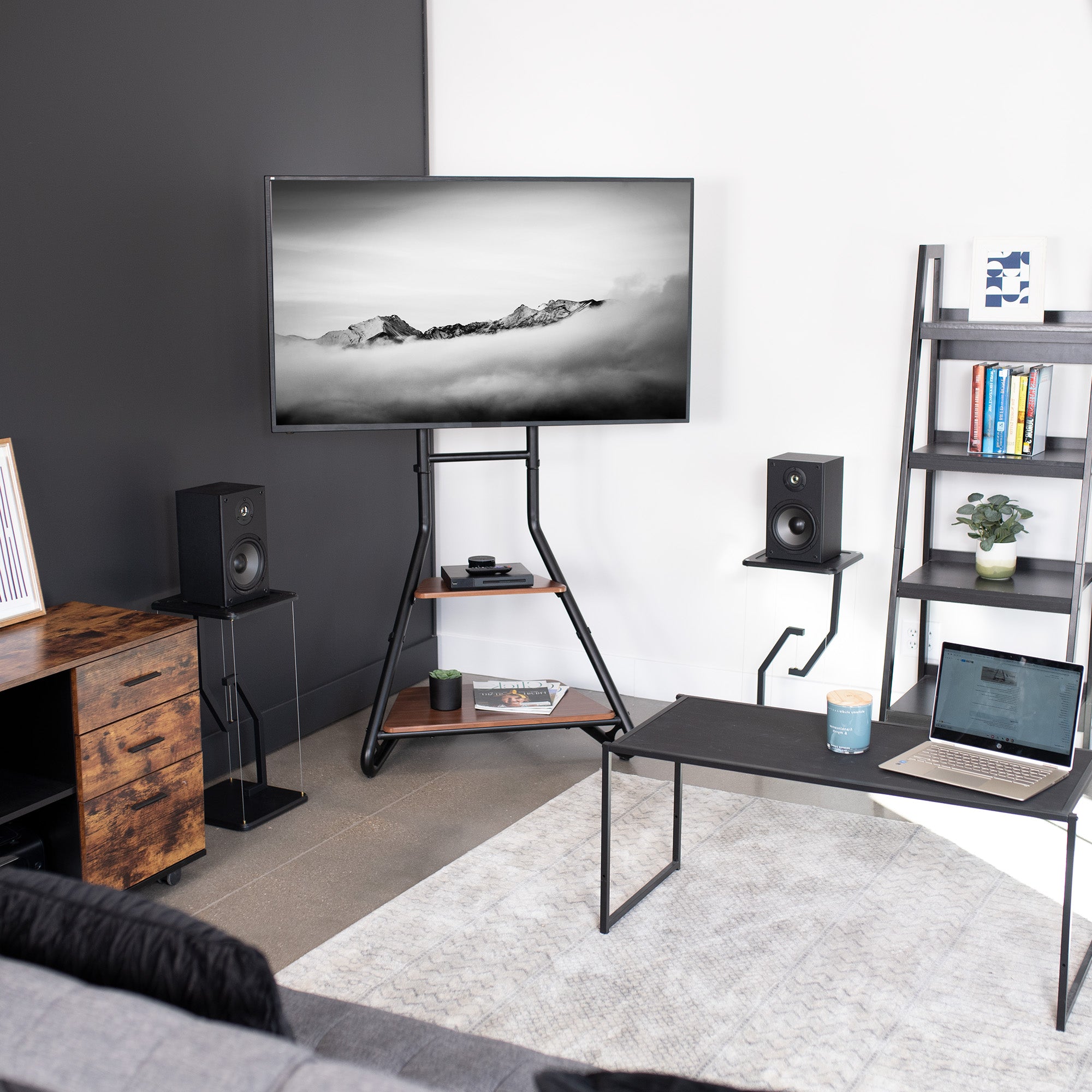 A modern living space with a corner of the room TV stand, anti-gravity speaker stands, and a minimalist coffee table.