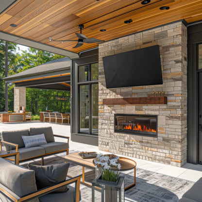 Outdoor patio with stone fireplace, TV and TV cover, and furniture