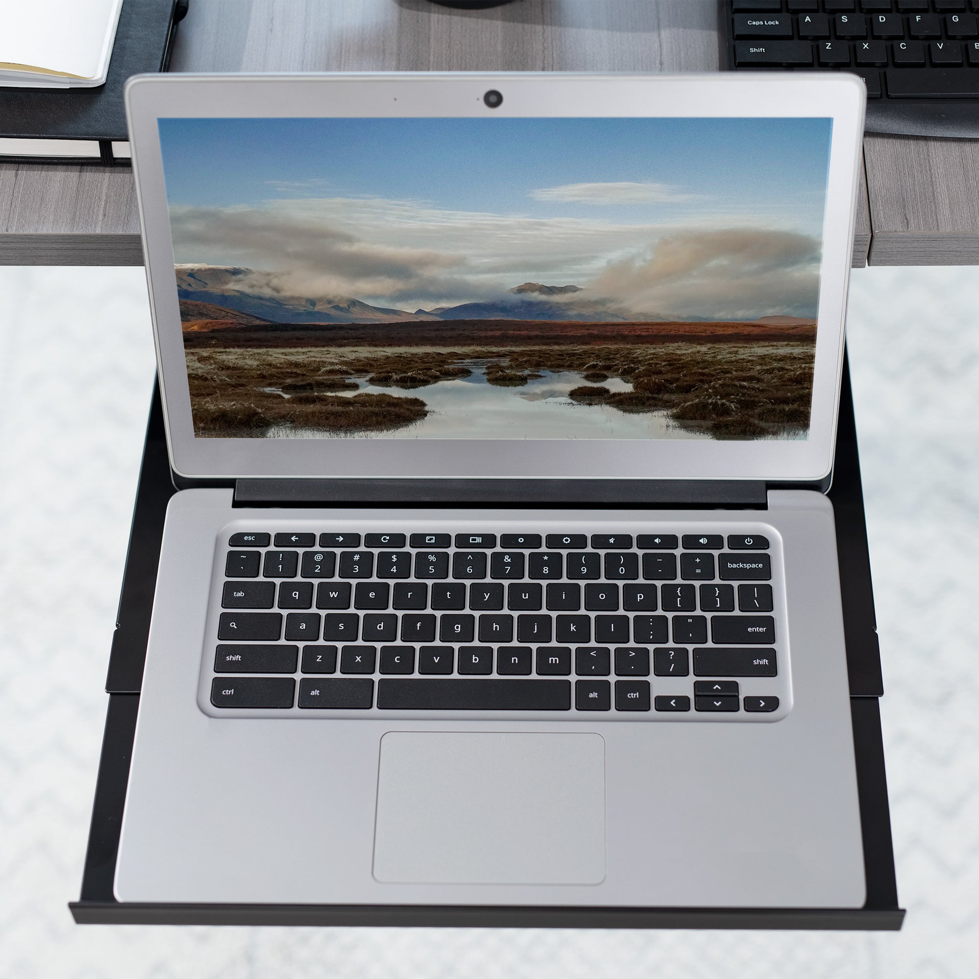 Under desk adjustable laptop tray lets you have comfortable typing angles as you work.