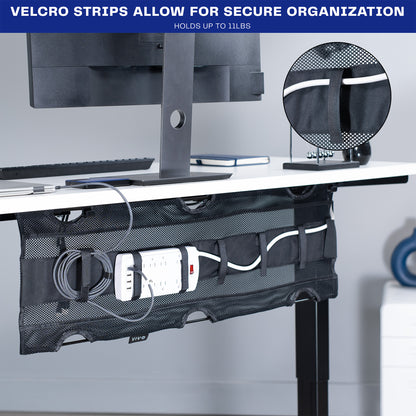 A black mesh cable management system with a power strip with Velcro strips for organization. 