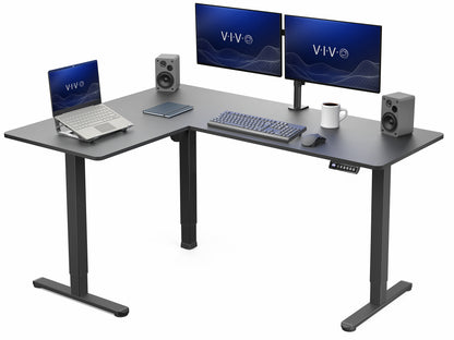 L-shaped desk with computer setup including two monitors, a laptop, keyboard, and speakers on a white background.