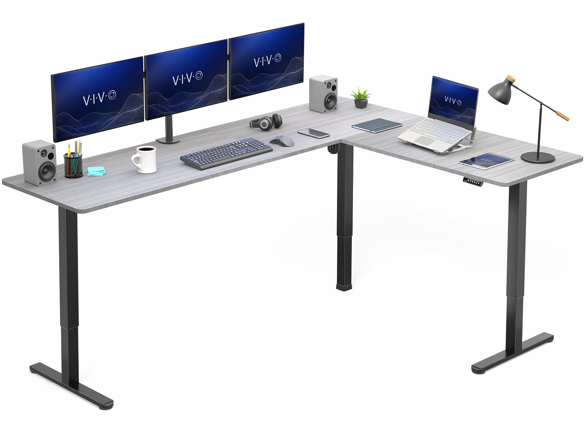 L-shaped desk with computer setup including monitors, keyboard, and laptop on a white background