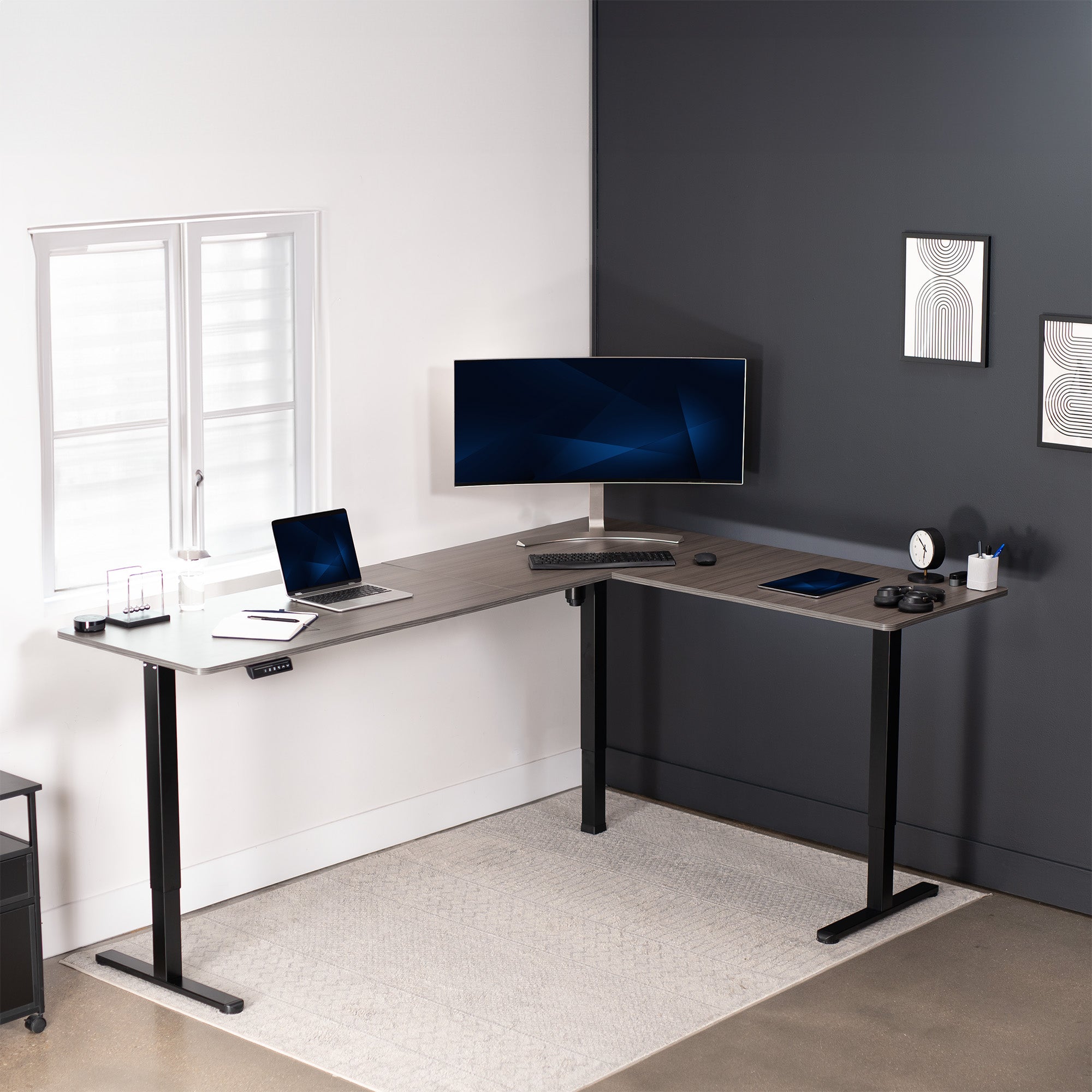 Electric heavy-duty large corner desk workstation for modern office workspaces.