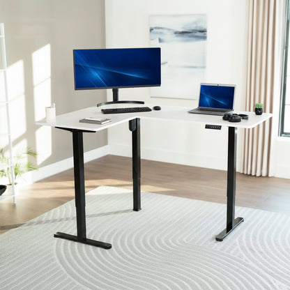White adjustable desk with computer setup in a bright room