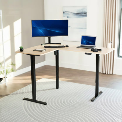L-shaped desk with computer setup in a bright room
