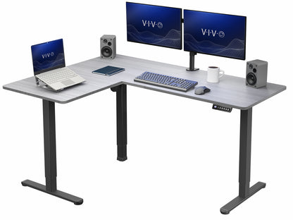 L-shaped desk with computer setup including monitors, keyboard, and speakers on a white background