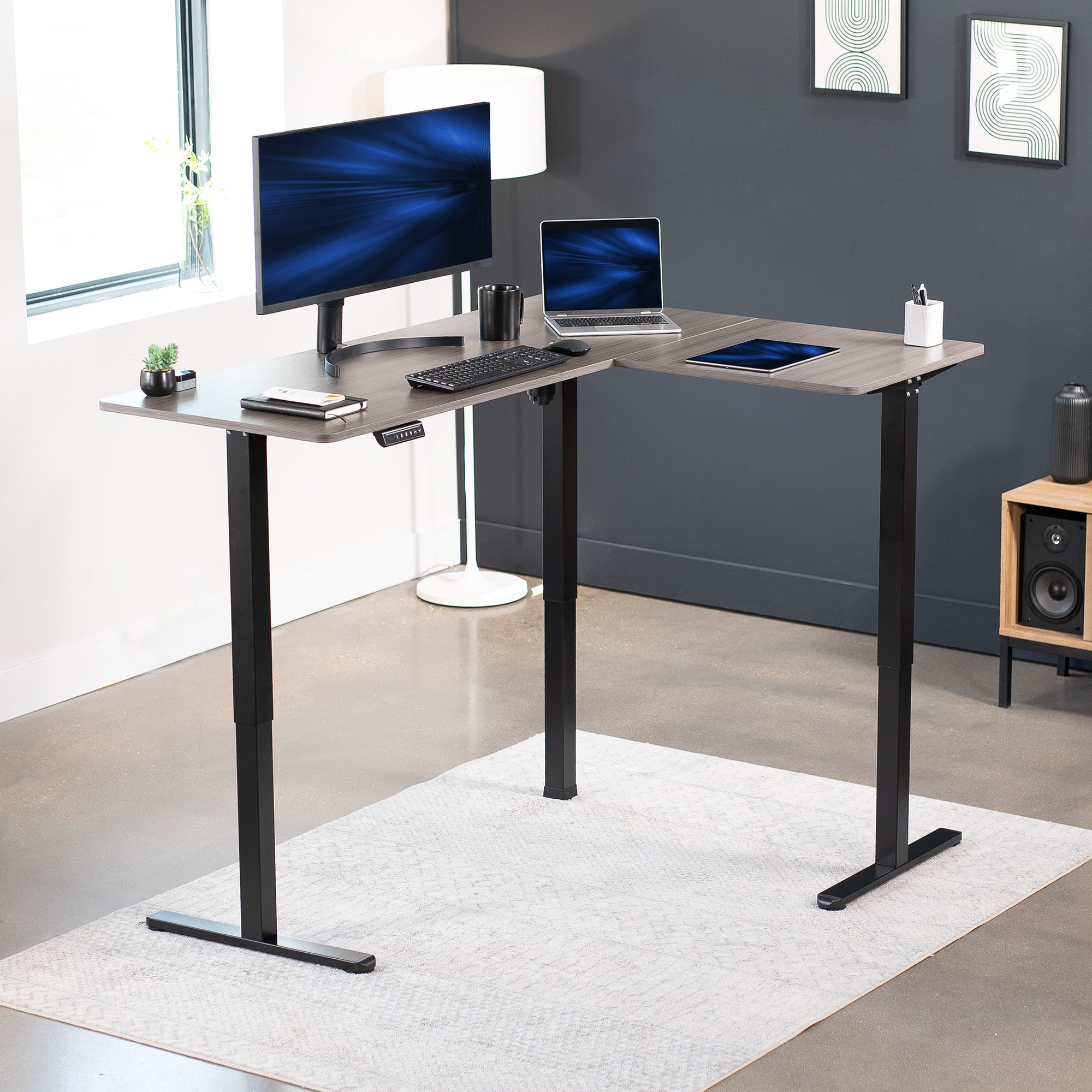 Electric heavy-duty corner desk workstation for modern office workspaces.