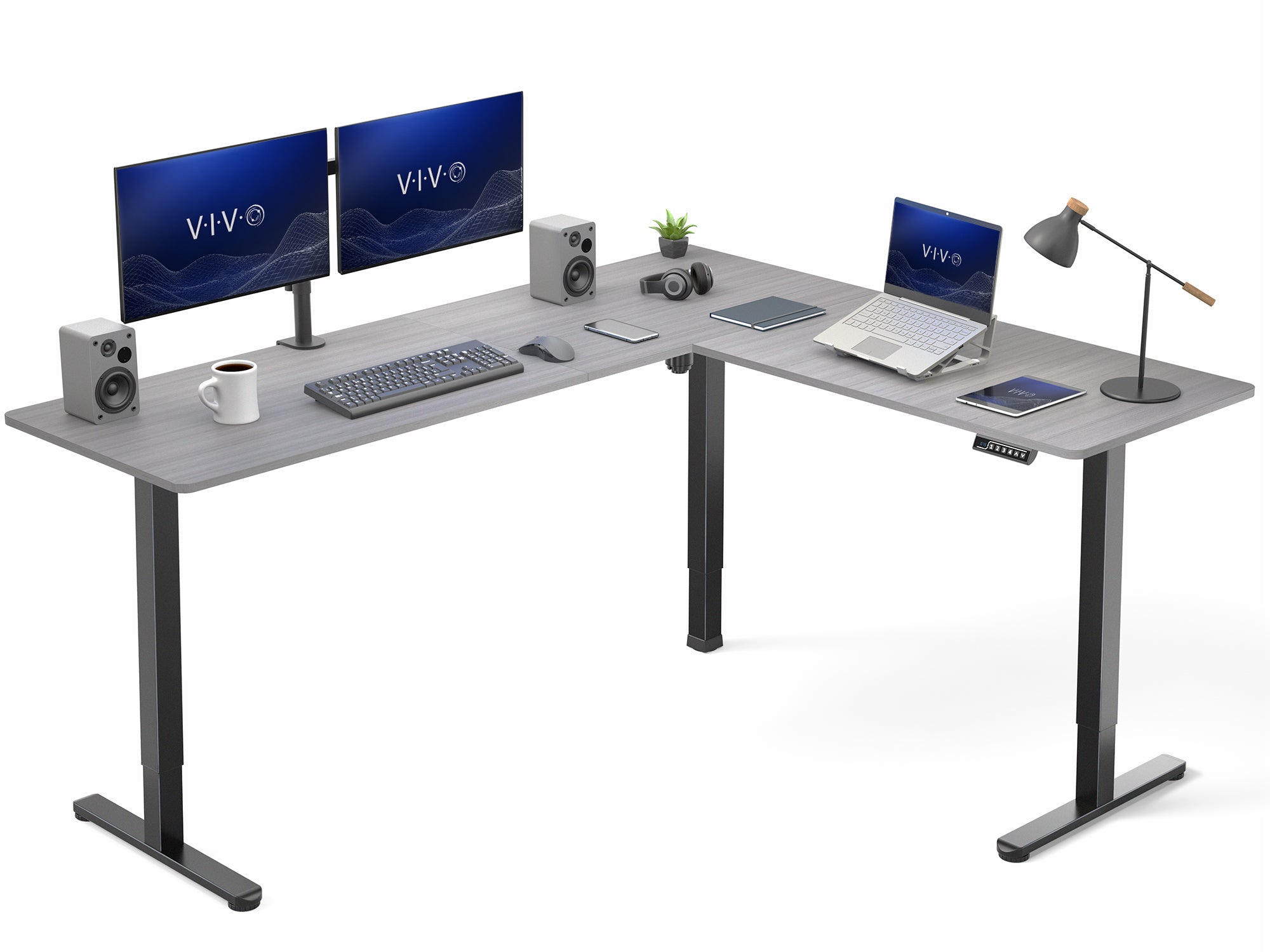 Gray and black l-shaped desk with computer setup on a white background