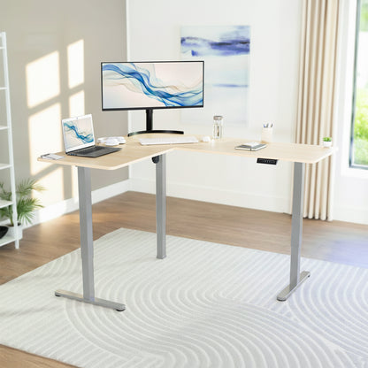 L-shaped desk with computer setup in a bright room