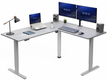 Modern L-shaped desk with computer setup including monitors, laptop, and office items on a white background.