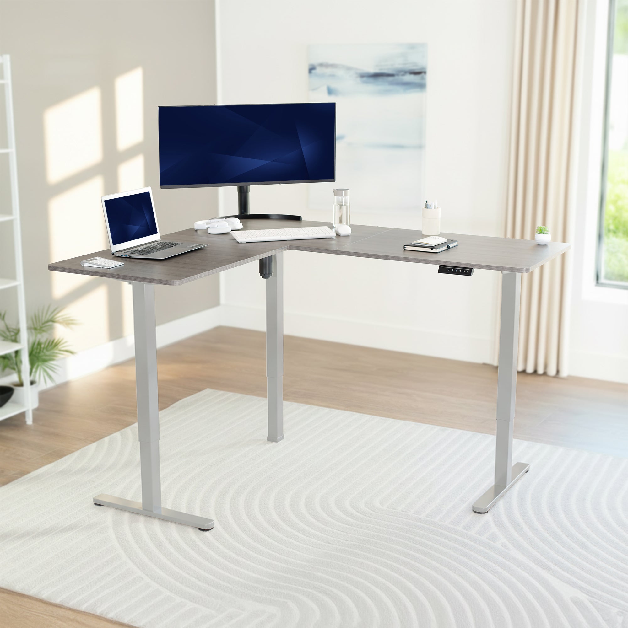 L-shaped desk with computer setup in a bright room