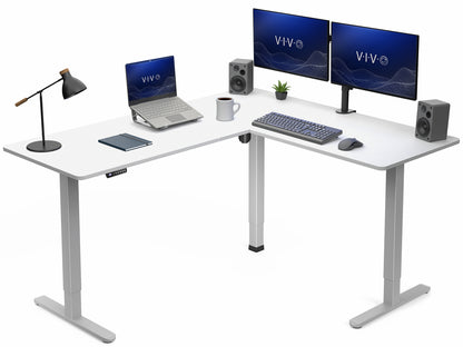 White L-shaped desk with computer setup including monitors, laptop, keyboard, and speakers on a white background.