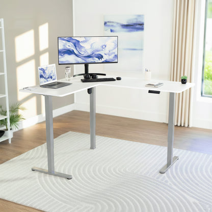 White L-shaped desk with computer setup in a bright room