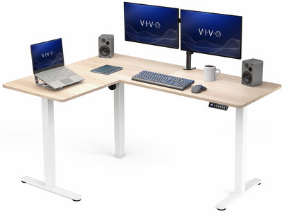 L-shaped desk with computer setup including two monitors, a laptop, keyboard, and speakers on a white background.