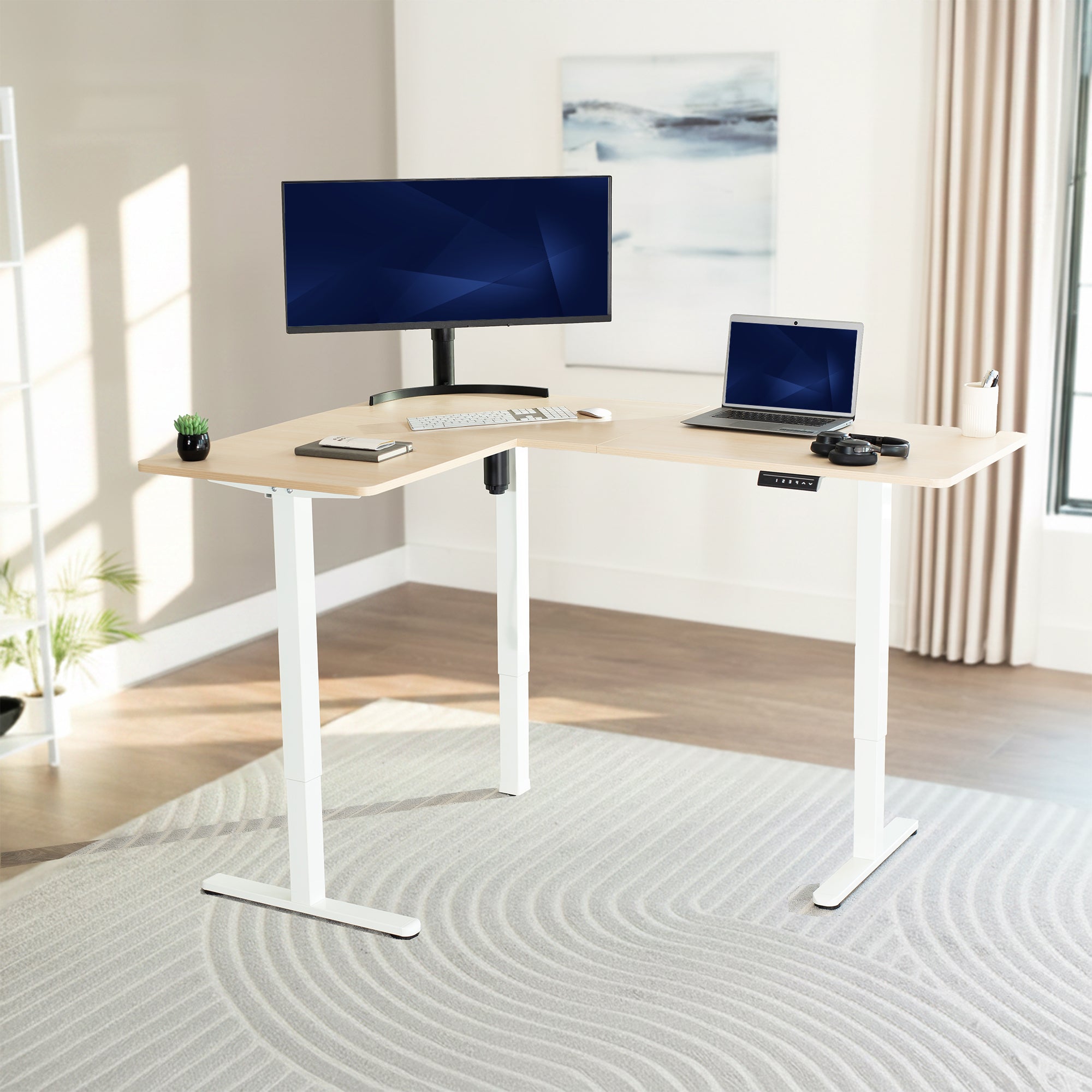 L-shaped desk with computer setup in a bright room