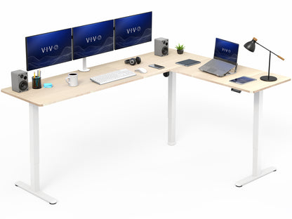 L-shaped desk with computer setup including monitors, keyboard, and laptop on a white background