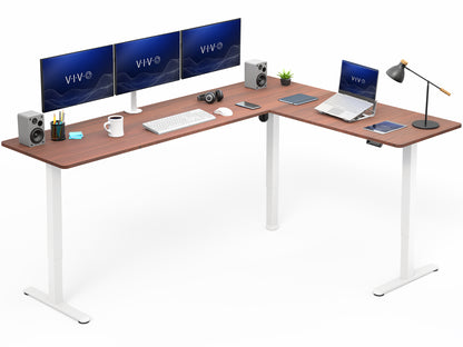 L-shaped desk with computer setup including monitors, keyboard, and laptop on a white background
