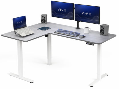 L-shaped desk with computer setup including monitors, laptop, keyboard, and speakers on a white background.