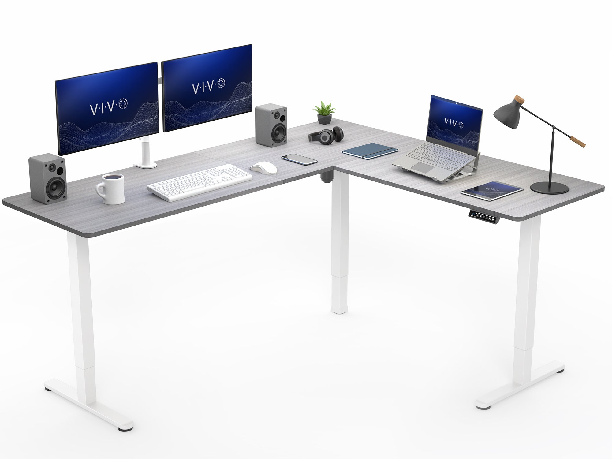 Gray L-shaped desk with computer setup on a white background