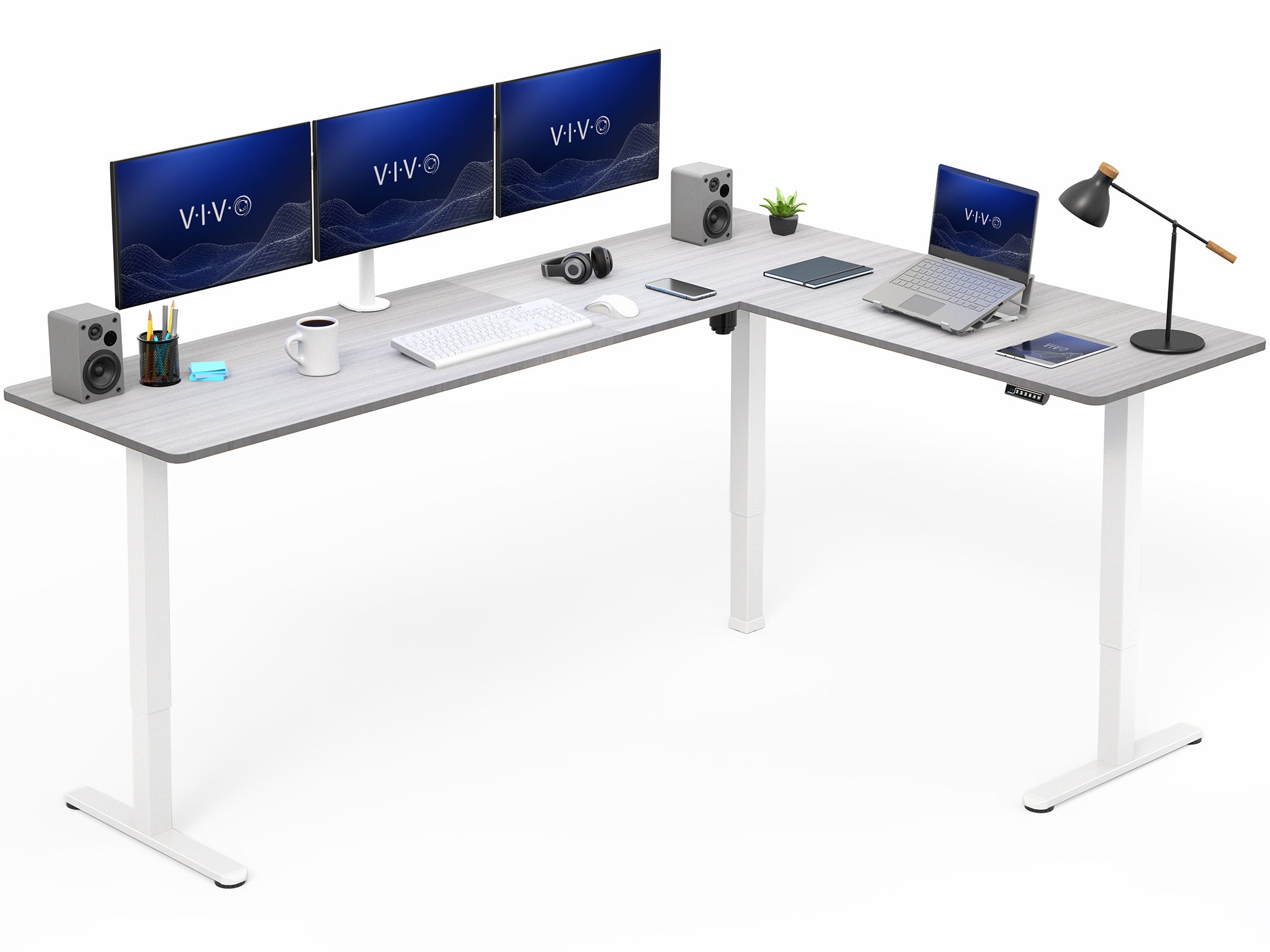 L-shaped desk with computer setup including monitors, keyboard, and laptop on a white background