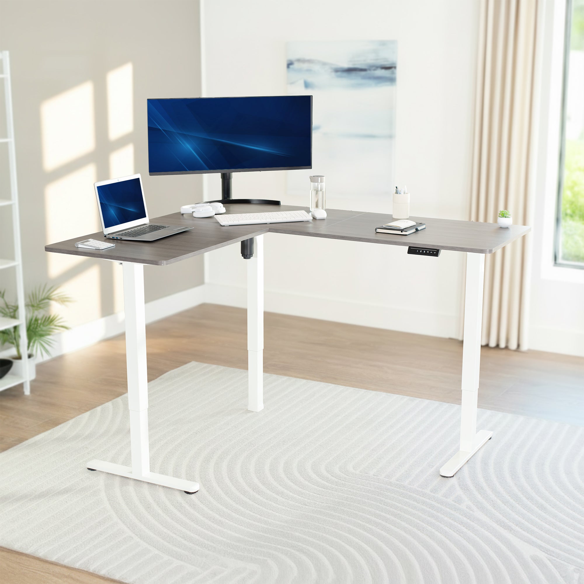 Modern L-shaped desk with computer setup in a bright room