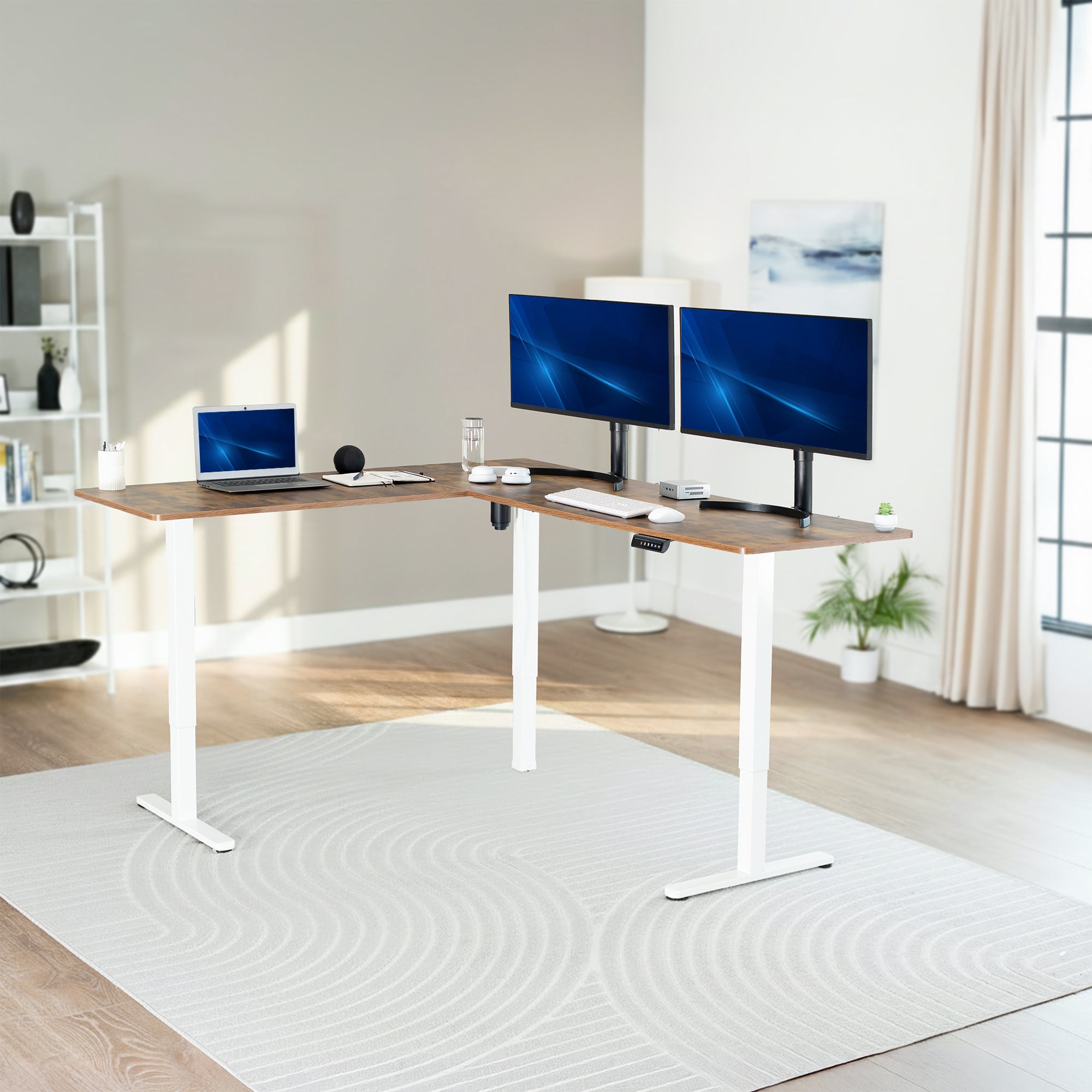 Modern home office with a adjustable l-shaped desk, computer setup, and decor.