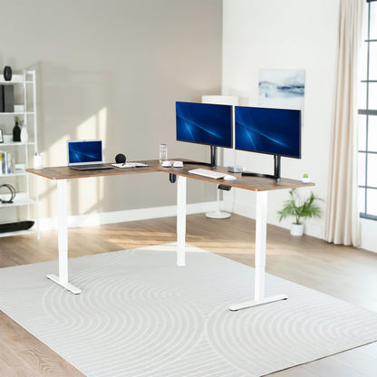 Modern home office with a adjustable l-shaped desk, computer setup, and decor.
