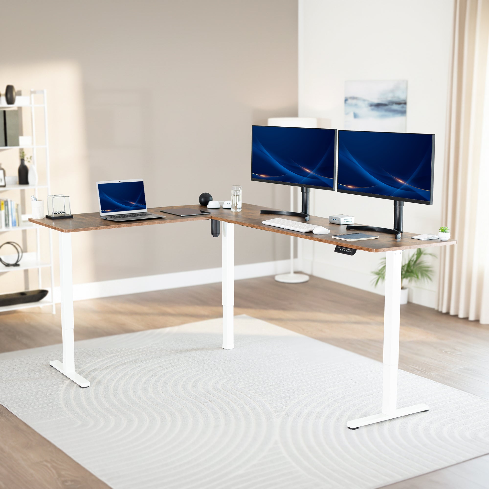 Modern office setup with a vintage brown adjustable desk, laptop, and two monitors in a home office.