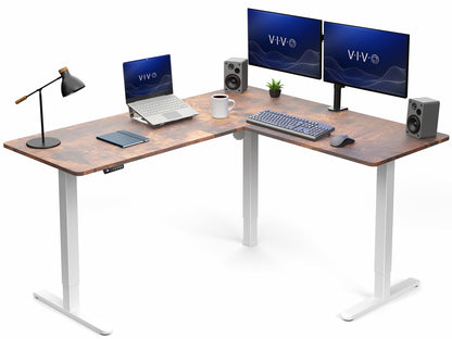 Wooden L-shaped desk with computer setup including two monitors, laptop, keyboard, and speakers on a white background.