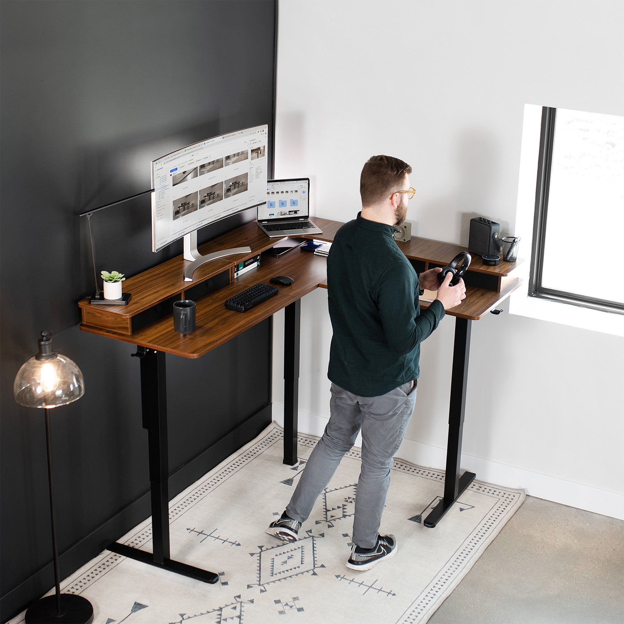 Spacious workstation surface with built-in shelving supporting multiple monitors.