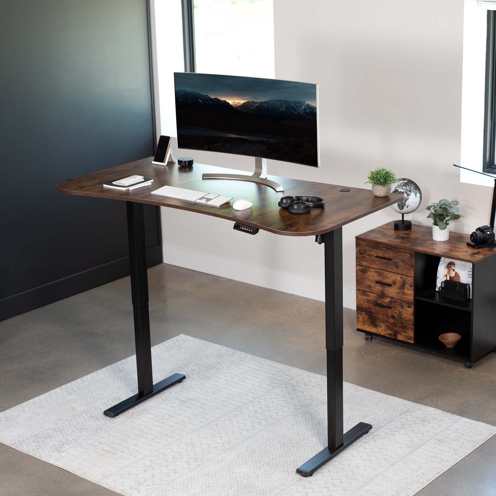 Rustic sit to stand height adjustable electric desk with push button memory controller for ergonomic office workstation.