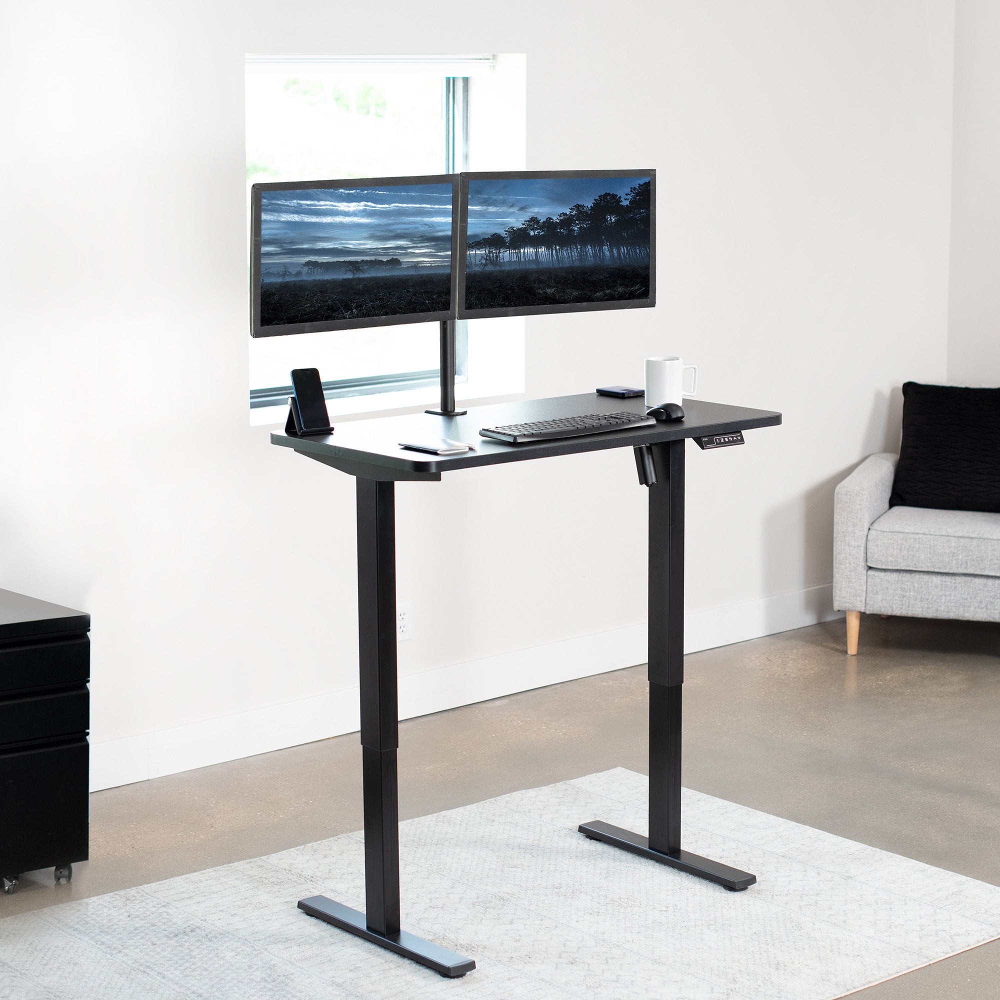 Sturdy ergonomic sit or stand active desk workstation with adjustable height using smart control panel.