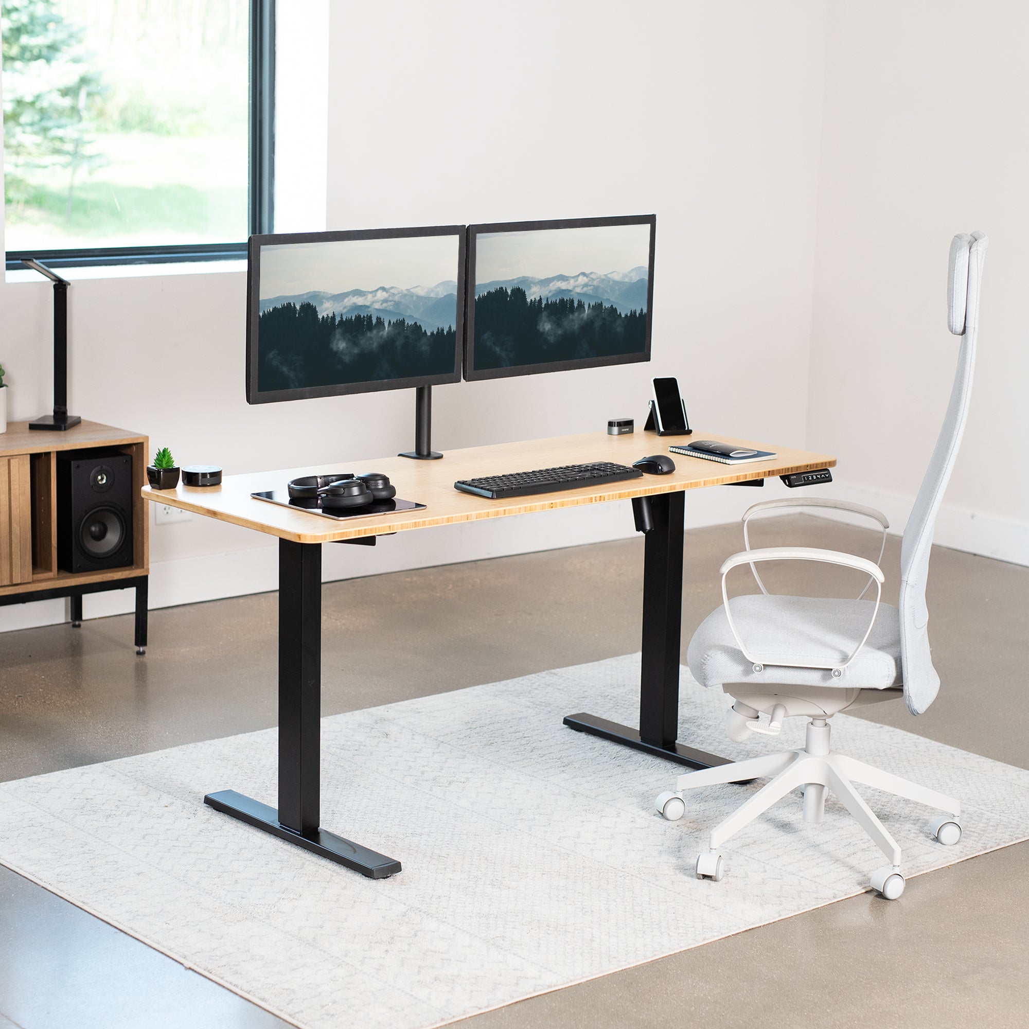 Sturdy real bamboo ergonomic sit or stand active desk workstation with adjustable height using smart control panel.