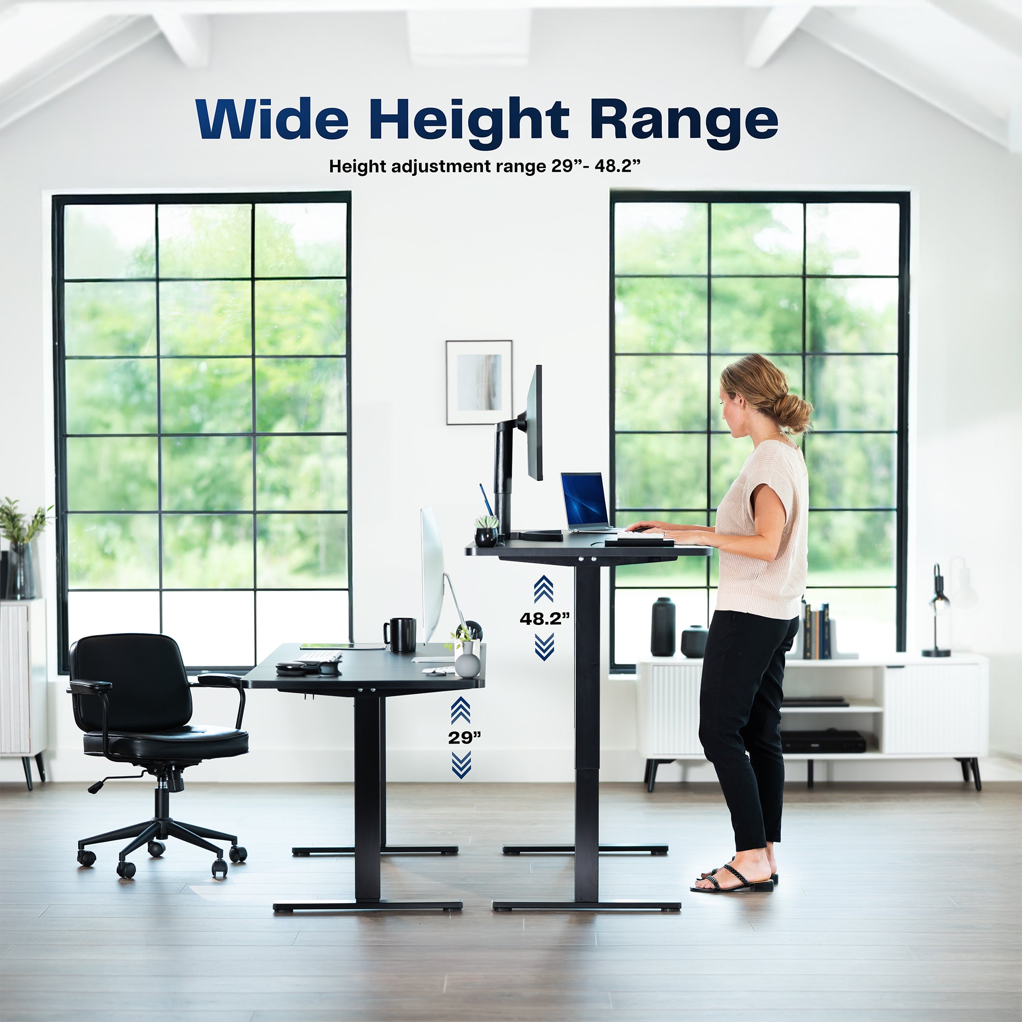 Woman using a standing desk with height adjustment range displayed