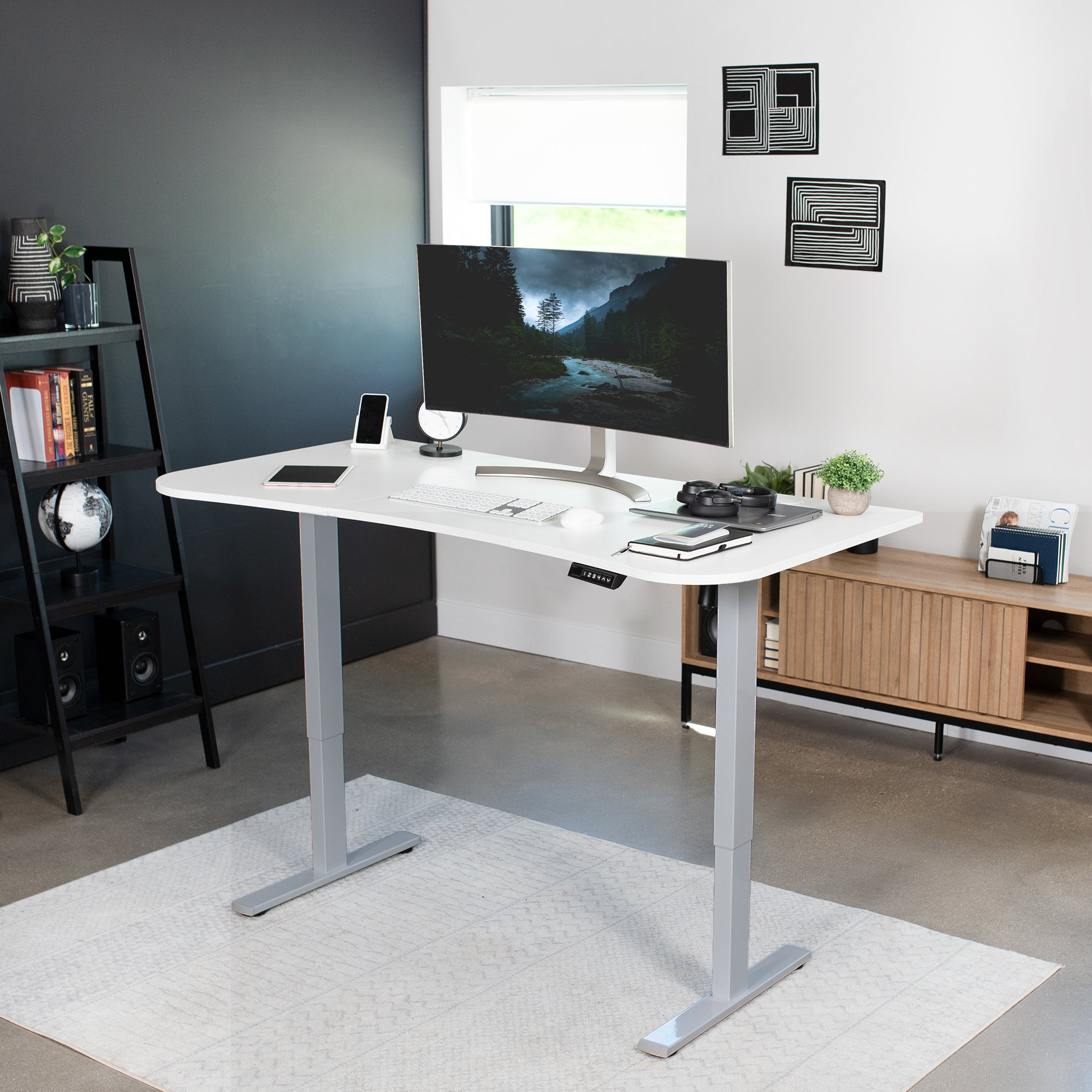 Sit to stand height adjustable electric desk with push button memory controller for ergonomic office workstation.