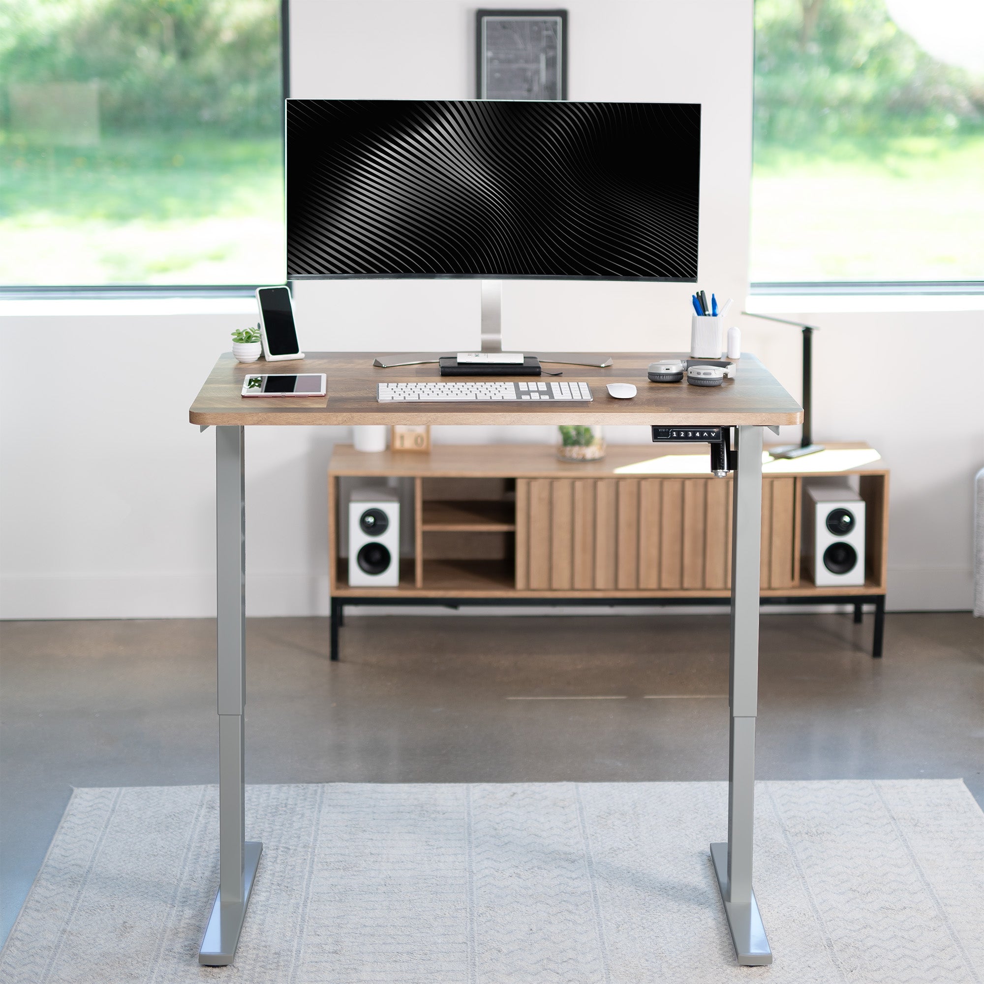 Sturdy ergonomic sit or stand active desk workstation with adjustable height using smart control panel.