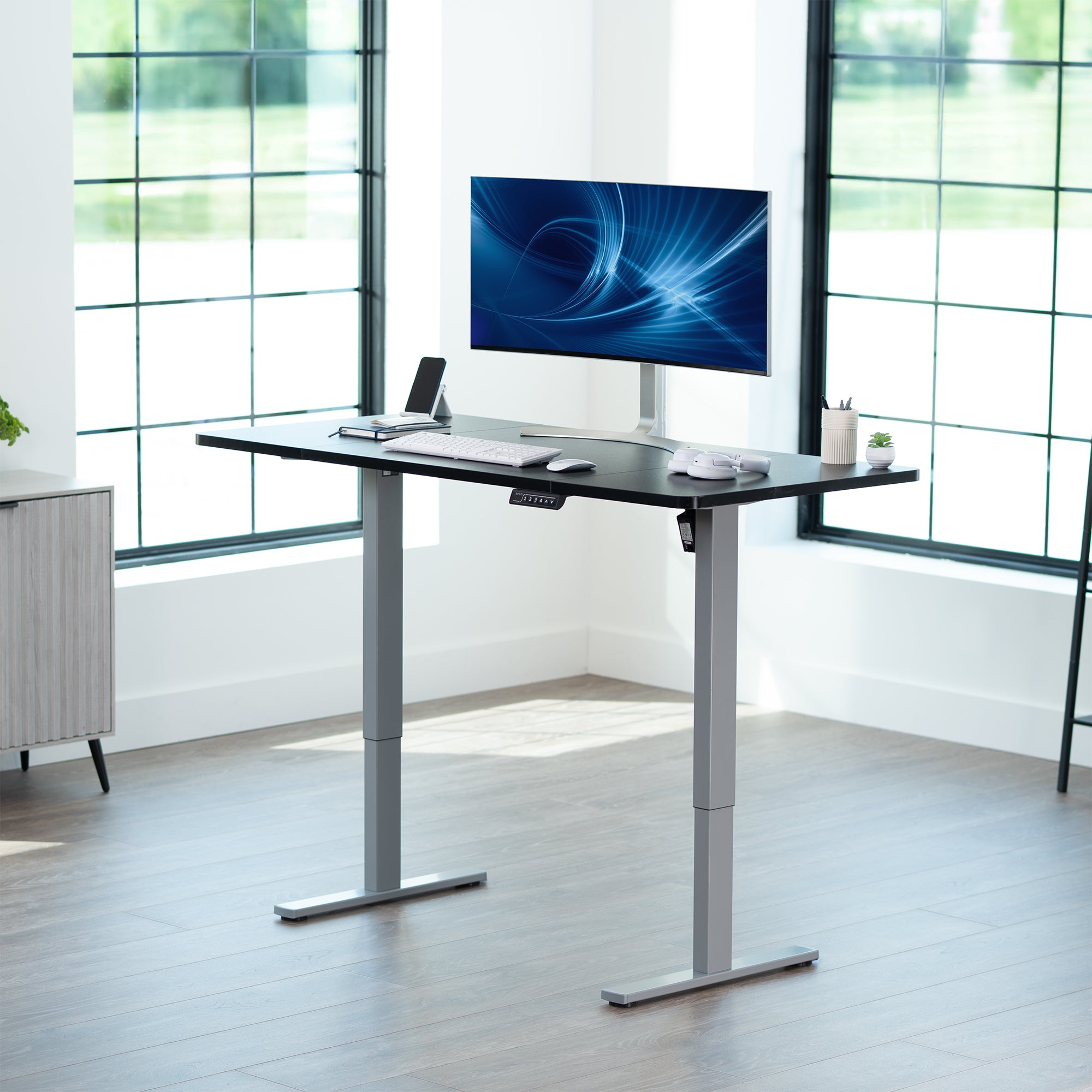 Sturdy ergonomic sit or stand active desk workstation with adjustable height using smart control panel.