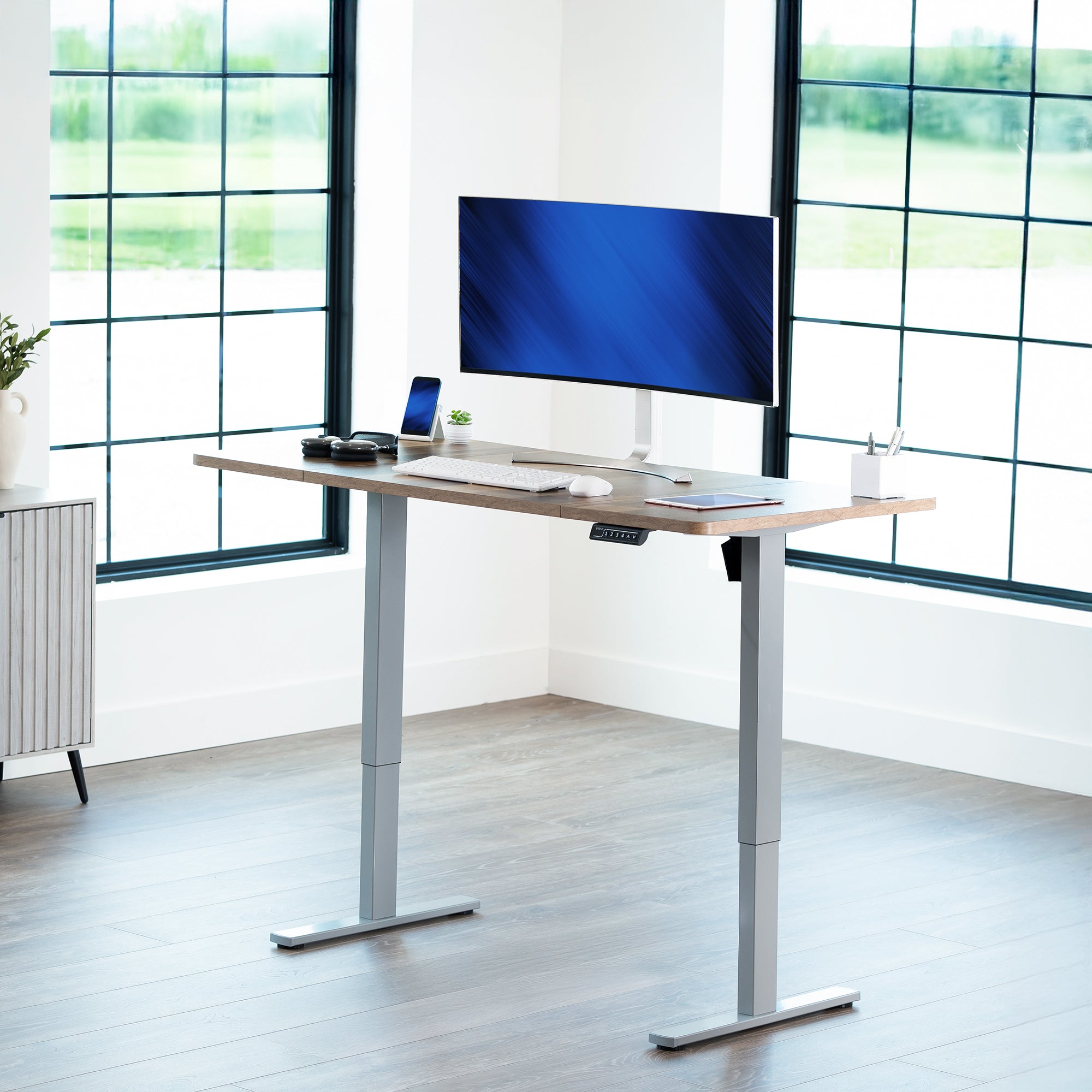 Sturdy ergonomic sit or stand active desk workstation with adjustable height using smart control panel.