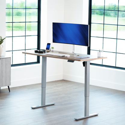 Sturdy ergonomic sit or stand active desk workstation with adjustable height using smart control panel.