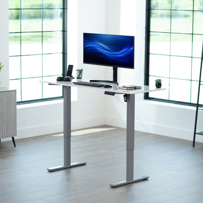 Sturdy ergonomic sit or stand active desk workstation with adjustable height using smart control panel.