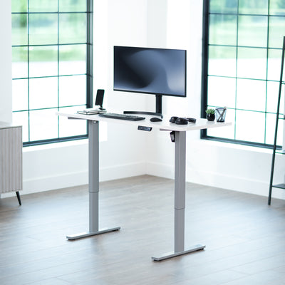 Sturdy ergonomic sit or stand active desk workstation with adjustable height using smart control panel.