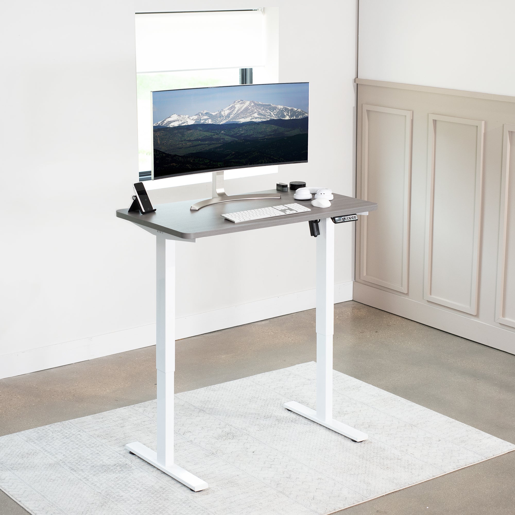 Sturdy ergonomic sit or stand active desk workstation with adjustable height using smart control panel.