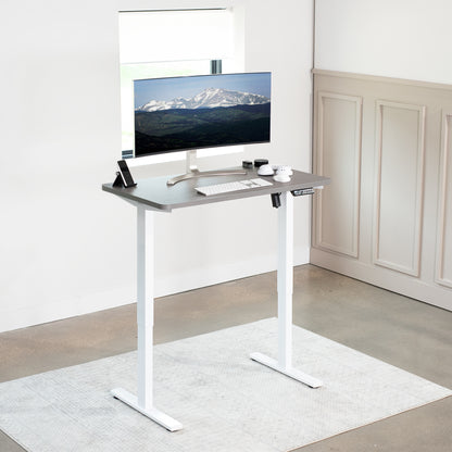 Sturdy ergonomic sit or stand active desk workstation with adjustable height using smart control panel.