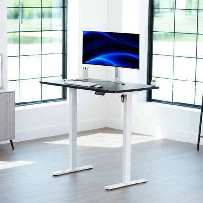 Sturdy ergonomic sit or stand active desk workstation with adjustable height using smart control panel.