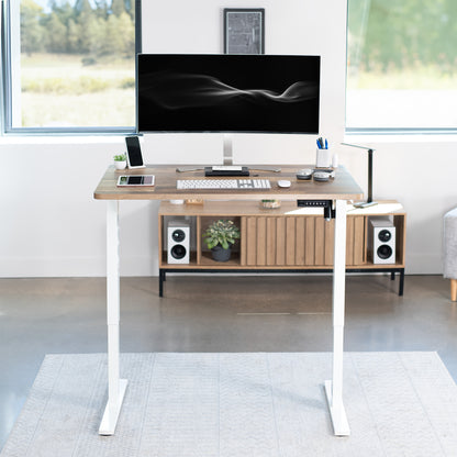 Sturdy ergonomic sit or stand active desk workstation with adjustable height using smart control panel.