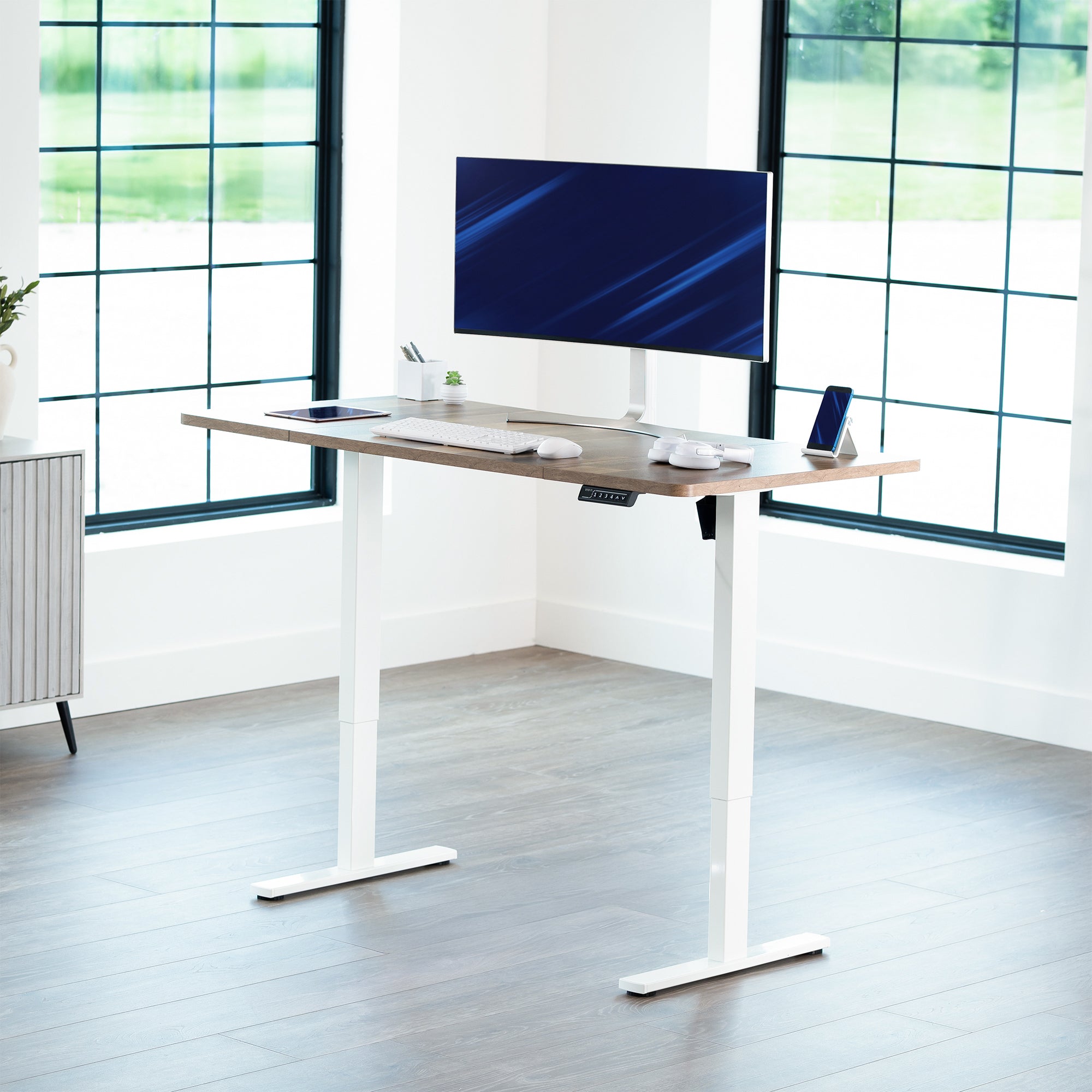 Sturdy ergonomic sit or stand active desk workstation with adjustable height using smart control panel.